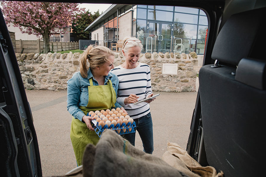 Delivery driver dropping off eggs to customer.