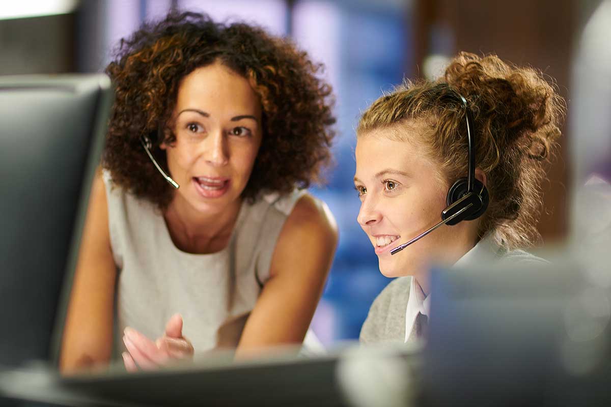 Claims agents reviewing info on a monitor