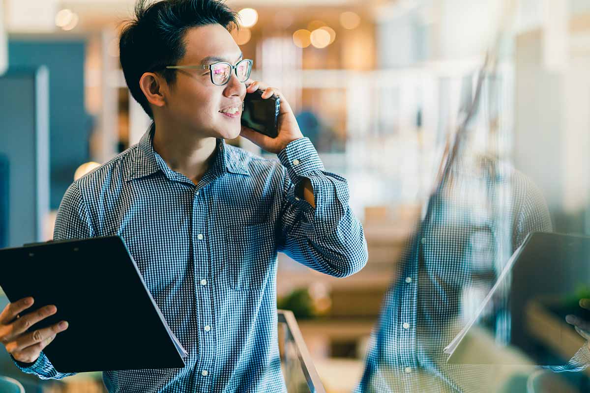 Man speaking on phone with customer