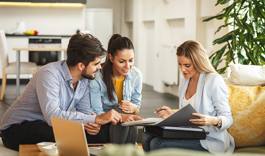 Couple meeting with insurance agent at home.