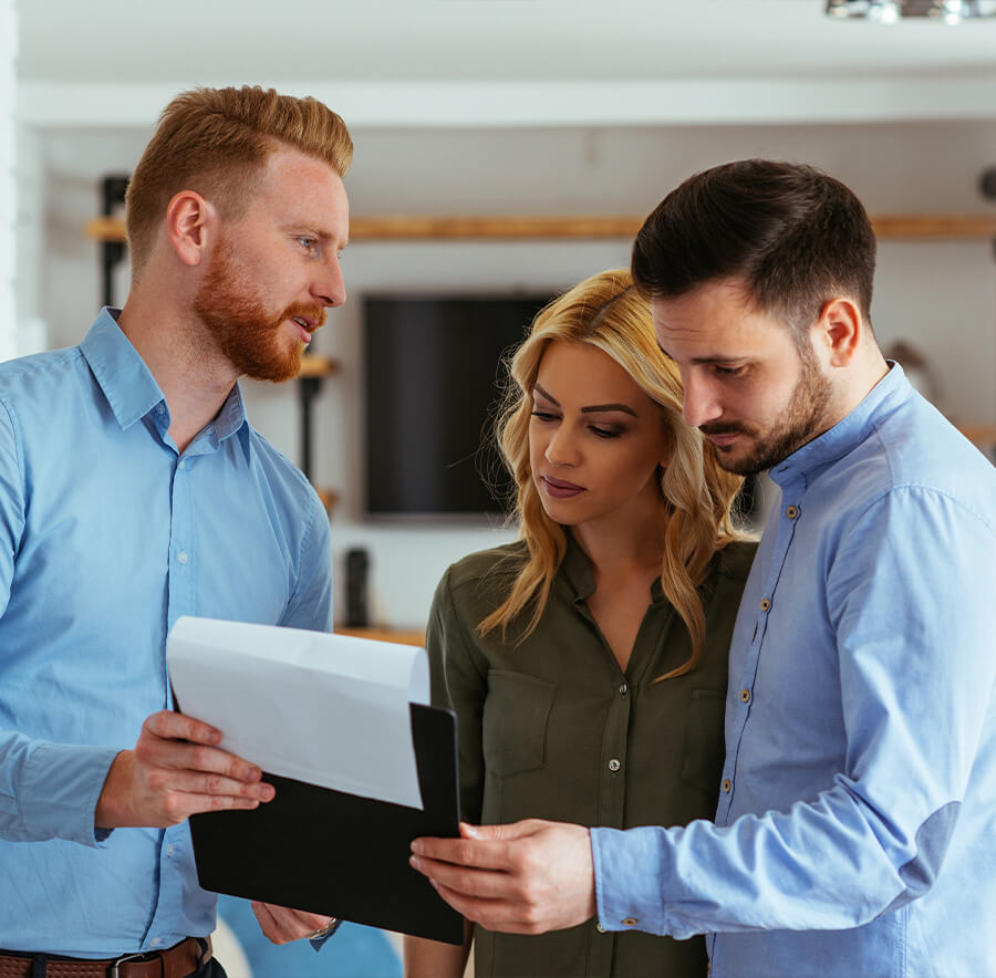 Couple reviewing insurance quote with agent.