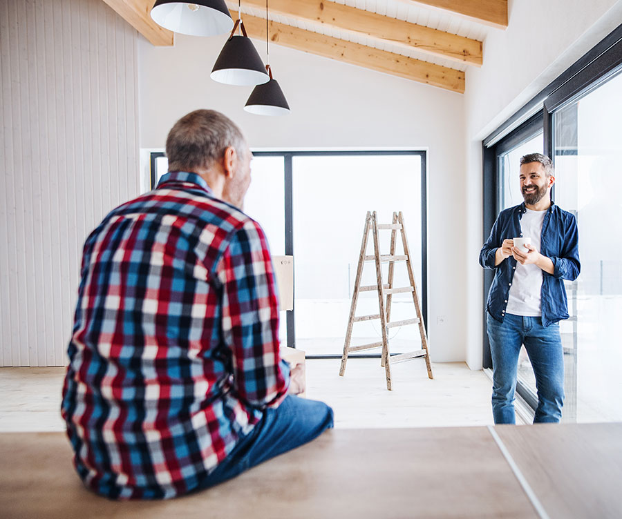 Two men talking in a home.